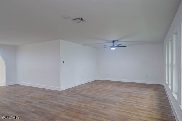 spare room with baseboards, visible vents, ceiling fan, and light wood finished floors