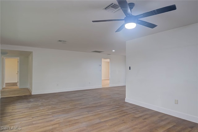 unfurnished room featuring a ceiling fan, light wood-type flooring, visible vents, and baseboards