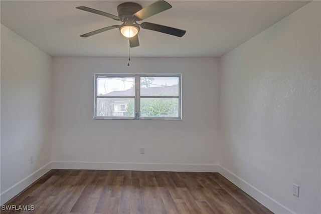 spare room with a ceiling fan, dark wood-style flooring, and baseboards