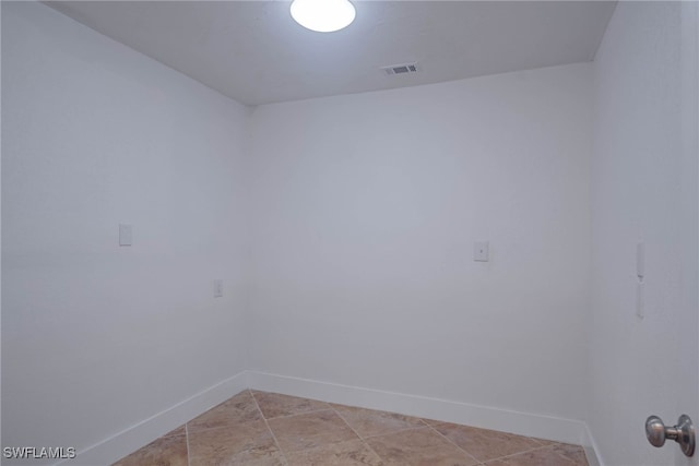 spare room with baseboards and visible vents