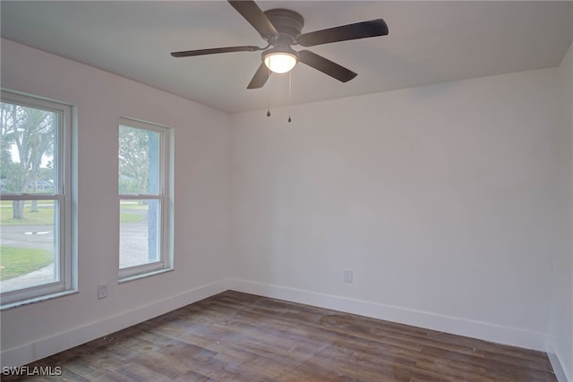 unfurnished room featuring wood finished floors and baseboards