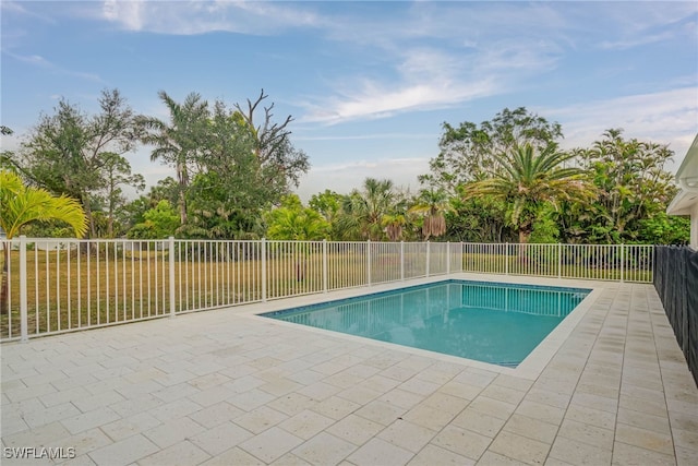 view of swimming pool with a fenced in pool, a fenced backyard, and a patio