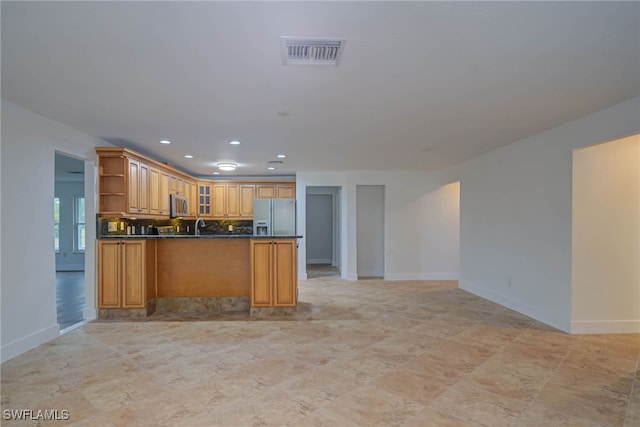 kitchen with open shelves, stainless steel appliances, dark countertops, visible vents, and glass insert cabinets