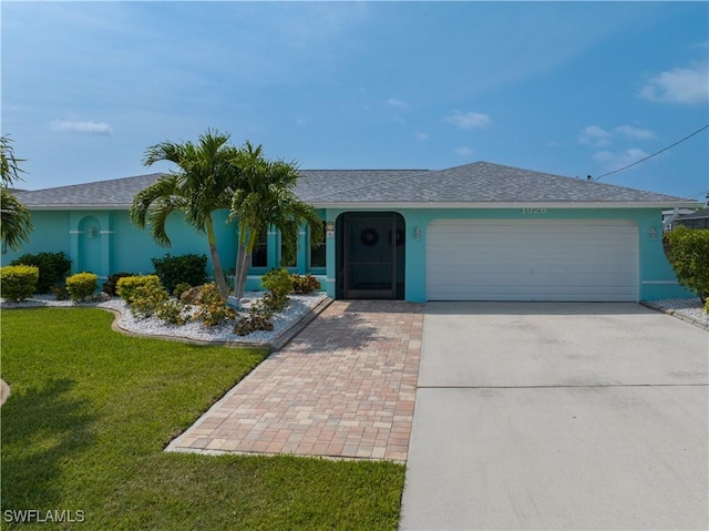 ranch-style home featuring a garage and a front lawn