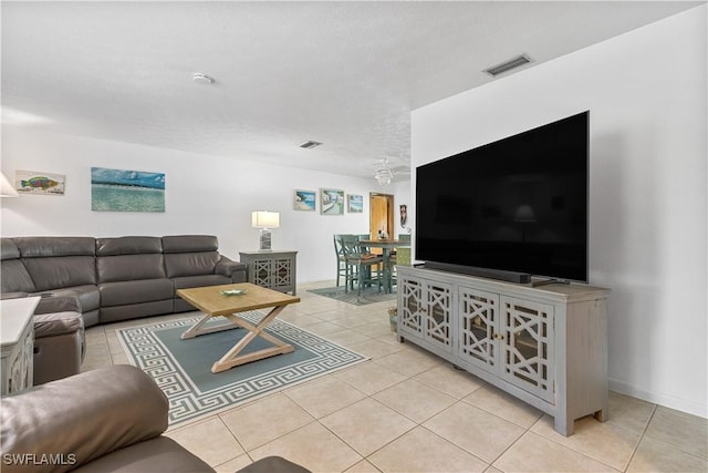 tiled living room featuring a textured ceiling