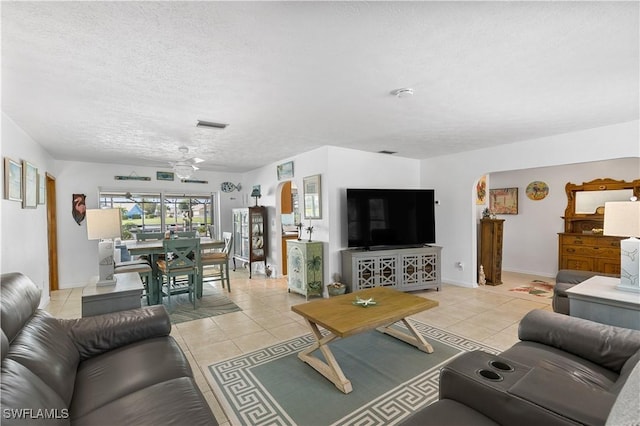 living room featuring light tile patterned floors and a textured ceiling