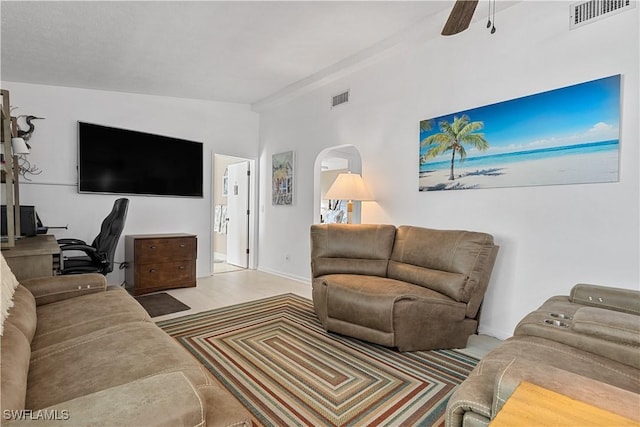 living room featuring ceiling fan and vaulted ceiling