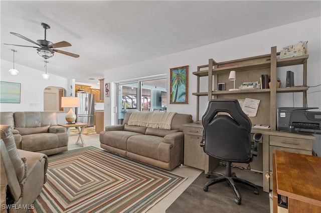 carpeted office space with lofted ceiling and ceiling fan