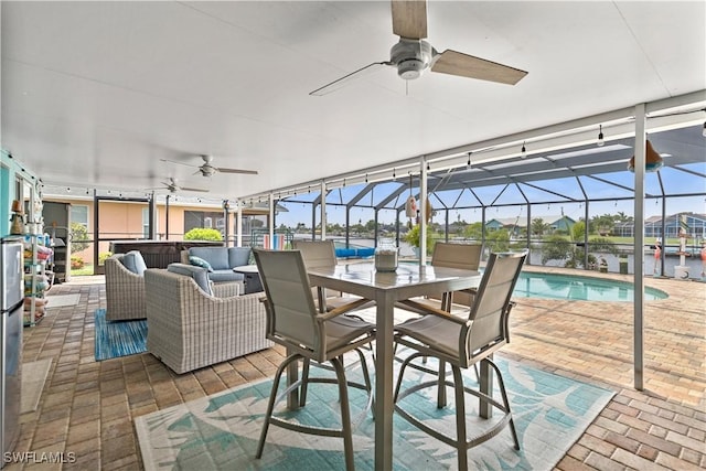 view of patio featuring a water view, ceiling fan, and outdoor lounge area