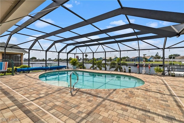 view of swimming pool with a lanai, a patio area, and a water view