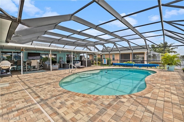 view of pool with a patio area and glass enclosure