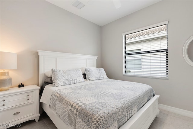 bedroom featuring light tile patterned floors and ceiling fan