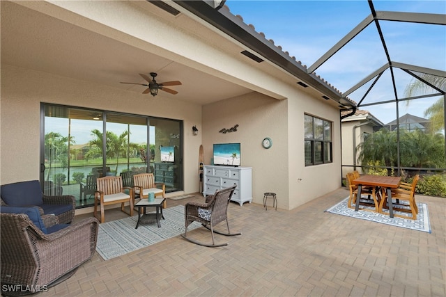 view of patio / terrace featuring ceiling fan, an outdoor living space, and a lanai