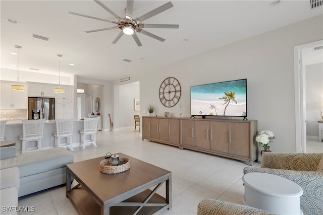 living room featuring light tile patterned flooring and ceiling fan