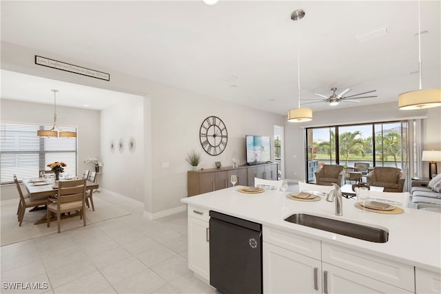 kitchen with pendant lighting, white cabinetry, dishwasher, sink, and light tile patterned floors