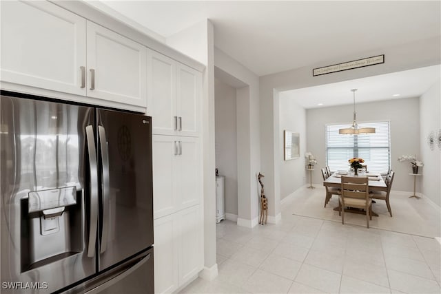 kitchen with white cabinetry, pendant lighting, light tile patterned floors, and stainless steel fridge with ice dispenser