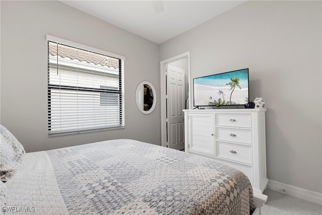 bedroom featuring light tile patterned floors and ceiling fan