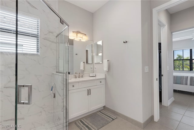 bathroom featuring tile patterned floors, vanity, and a shower with door