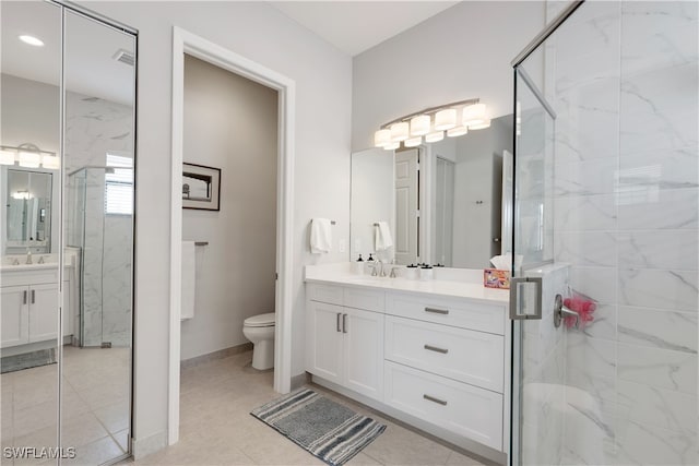 bathroom with vanity, toilet, and an enclosed shower