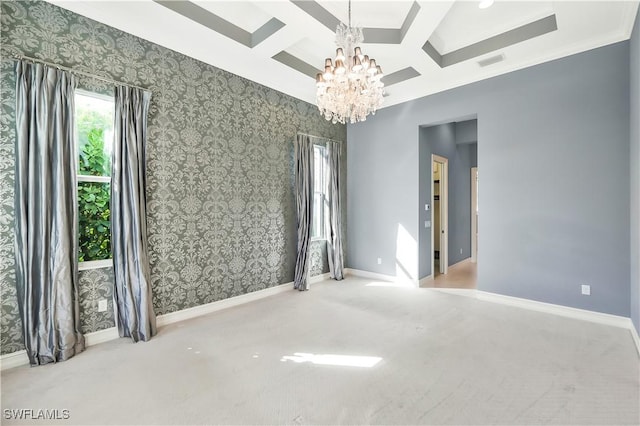 carpeted spare room with beam ceiling, a chandelier, and coffered ceiling