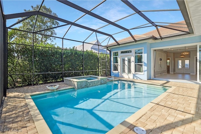 view of swimming pool featuring a patio, french doors, an in ground hot tub, and a lanai