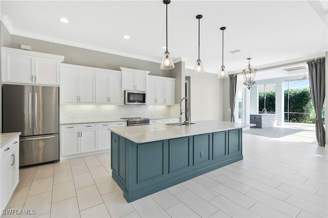 kitchen featuring hanging light fixtures, an island with sink, white cabinetry, and stainless steel appliances