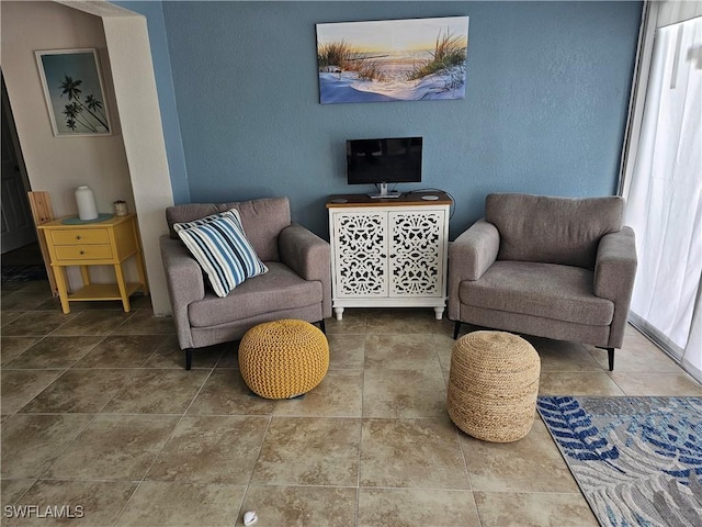 sitting room featuring tile patterned flooring