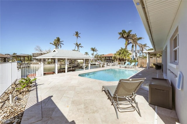 view of swimming pool with a patio, fence, and a fenced in pool