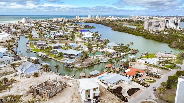 birds eye view of property with a water view and a city view