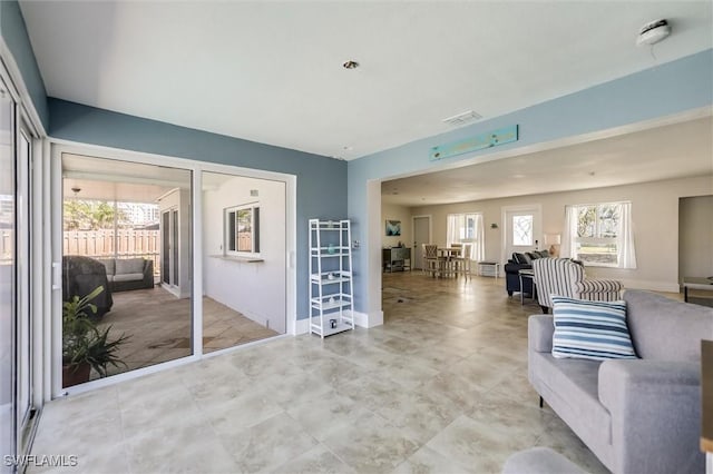 living area with visible vents and baseboards