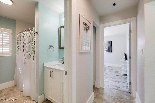 bathroom with vanity and baseboards