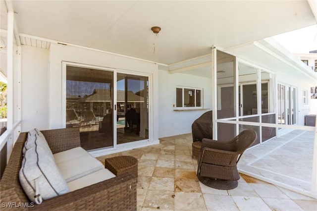 view of patio / terrace featuring a sunroom