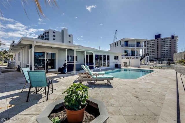 community pool featuring a patio area and fence