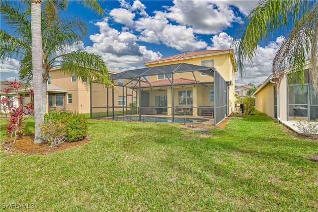 rear view of property with a lanai and a lawn