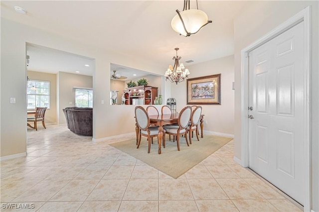 dining space featuring ceiling fan with notable chandelier and light tile patterned floors