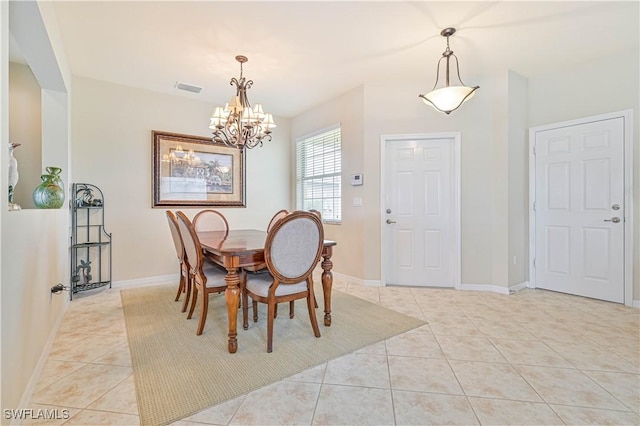 dining space featuring light tile patterned floors and an inviting chandelier