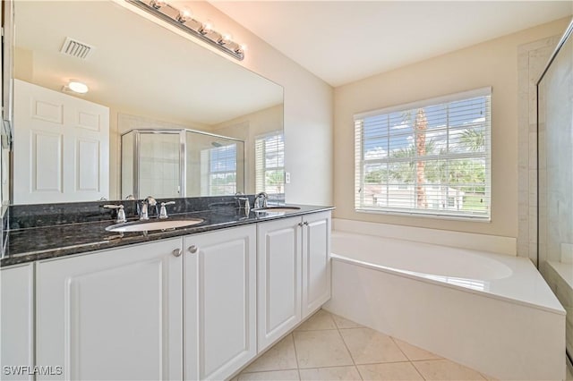 bathroom with tile patterned flooring, vanity, and shower with separate bathtub