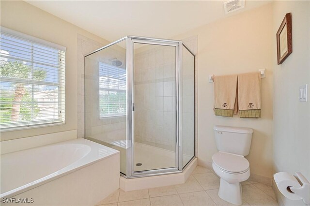 bathroom with tile patterned flooring, toilet, and shower with separate bathtub