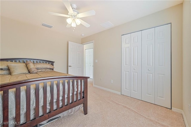 carpeted bedroom featuring a closet and ceiling fan