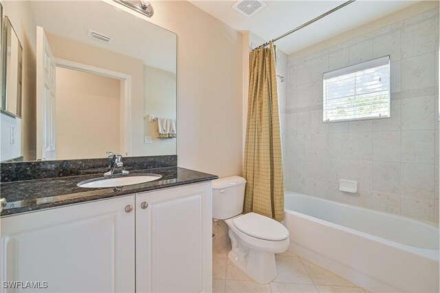 full bathroom featuring tile patterned flooring, toilet, vanity, and shower / tub combo with curtain