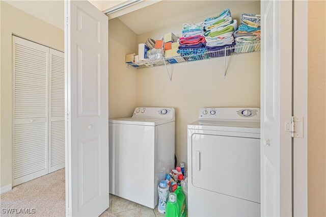 washroom with washing machine and clothes dryer