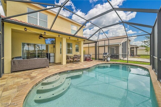 view of swimming pool featuring glass enclosure, an outdoor hangout area, ceiling fan, and a patio