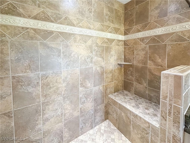 bathroom with a tile shower