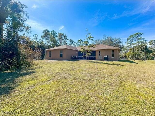 rear view of house with a lawn