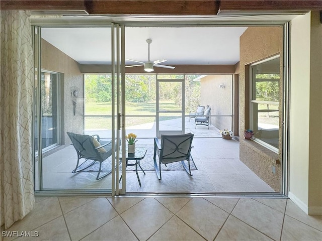 sunroom with a wealth of natural light and ceiling fan