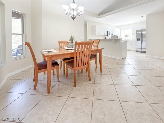 tiled dining space featuring a notable chandelier