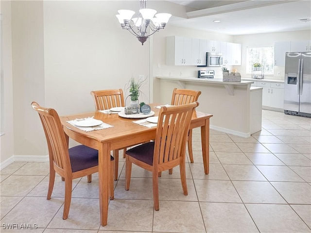 dining area featuring a notable chandelier and light tile patterned floors