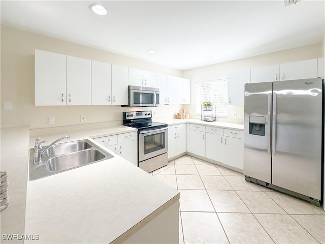 2910 2nd St NE, Naples, FL 34120 - kitchen with stainless steel appliances, a sink, light countertops, light tile patterned floors, and recessed lighting