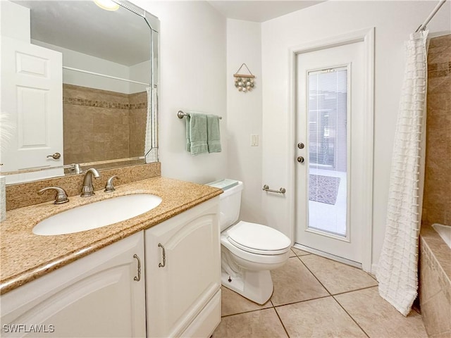 bathroom with tile patterned flooring, vanity, and toilet