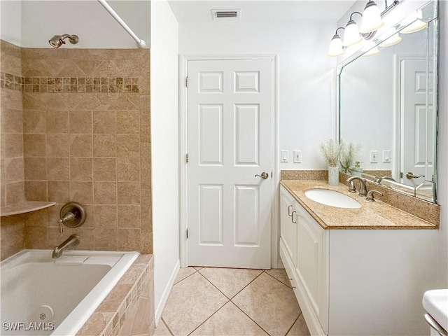 2910 2nd St NE, Naples, FL 34120 - bathroom with tile patterned flooring, vanity, and tiled shower / bath combo